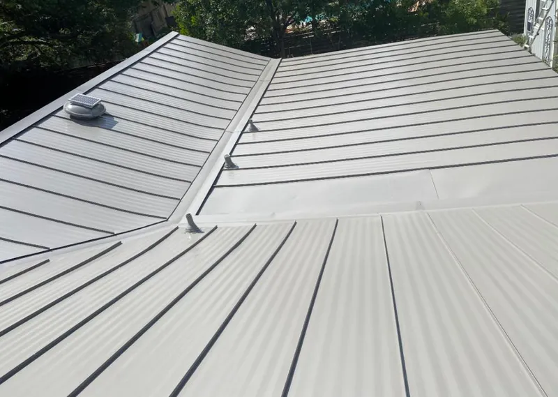 Solar attic fan installed on a metal roof for Roof Ventilation in Larose